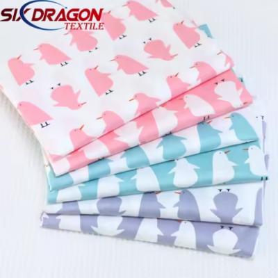 Cheap price woven material animal penguin print cotton fabric for garment